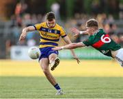 30 April 2025; Rory Carthy of Roscommon scores a goal despite the effort of John MacMonagle of Mayo during the Dalata Hotel Group Connacht GAA Football U20 Championship final match between Mayo and Roscommon at Tuam Stadium in Galway. Photo by Thomas Flinkow/Sportsfile