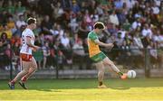30 April 2025; Finnbarr Roarty of Donegal passes as Conor O'Neill of Tyrone closes in during the Dalata Hotel Group Ulster GAA Football U20 Championship final match between Donegal and Tyrone at Owenbeg Derry GAA Centre in Dungiven, Derry. Photo by Piaras Ó Mídheach/Sportsfile