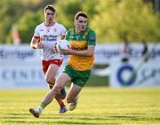 30 April 2025; Kevin Muldoon of Donegal gets away from Conor O'Neill of Tyrone during the Dalata Hotel Group Ulster GAA Football U20 Championship final match between Donegal and Tyrone at Owenbeg Derry GAA Centre in Dungiven, Derry. Photo by Piaras Ó Mídheach/Sportsfile