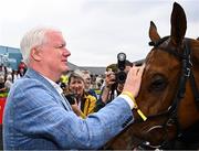 1 May 2025; Owner Brian Acheson and Teahupoo after winning the Ladbrokes Champion Stayers Hurdle during day three of the Punchestown Festival at Punchestown Racecourse in Kildare. Photo by Seb Daly/Sportsfile