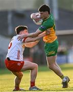 30 April 2025; Seanan Carr of Donegal in action against Joey Clarke of Tyrone during the Dalata Hotel Group Ulster GAA Football U20 Championship final match between Donegal and Tyrone at Owenbeg Derry GAA Centre in Dungiven, Derry. Photo by Piaras Ó Mídheach/Sportsfile