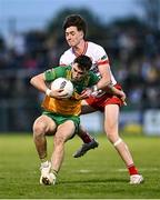 30 April 2025; Kevin Muldoon of Donegal in action against Matthew Quinn of Tyrone during the Dalata Hotel Group Ulster GAA Football U20 Championship final match between Donegal and Tyrone at Owenbeg Derry GAA Centre in Dungiven, Derry. Photo by Piaras Ó Mídheach/Sportsfile