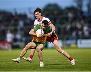 30 April 2025; Kevin Muldoon of Donegal in action against Matthew Quinn of Tyrone during the Dalata Hotel Group Ulster GAA Football U20 Championship final match between Donegal and Tyrone at Owenbeg Derry GAA Centre in Dungiven, Derry. Photo by Piaras Ó Mídheach/Sportsfile