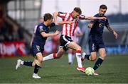 2 May 2025; Ronan Boyce of Derry City in action against James Norris, left, and Ellis Chapman of Shelbourne during the SSE Airtricity Men's Premier Division match between Derry City and Shelbourne at The Ryan McBride Brandywell Stadium in Derry. Photo by Stephen McCarthy/Sportsfile