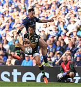 3 May 2025; Alex Mitchell of Northampton Saints loses possession as he is challenged by Hugo Keenan of Leinster during the Investec Champions Cup semi-final match between Leinster and Northampton Saints at the Aviva Stadium in Dublin. Photo by Brendan Moran/Sportsfile