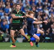 3 May 2025; Tommy O'Brien of Leinster is tackled by Juarno Augustus of Northampton Saints, behind, after the ball had been kicked during the Investec Champions Cup semi-final match between Leinster and Northampton Saints at the Aviva Stadium in Dublin. Photo by David Fitzgerald/Sportsfile