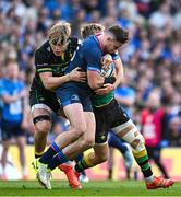 3 May 2025; Hugo Keenan of Leinster is tackled by Northampton Saints players Henry Pollock, left, and Fin Smith during the Investec Champions Cup semi-final match between Leinster and Northampton Saints at the Aviva Stadium in Dublin. Photo by Seb Daly/Sportsfile