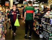 4 May 2025; Mayo and Galway supporters in a local garage before the Connacht GAA Football Senior Championship final match between Mayo and Galway at Hastings Insurance MacHale Park in Castlebar, Mayo. Photo by David Fitzgerald/Sportsfile