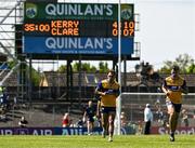 4 May 2025; Clare players Alan Sweeney and Cillian Brennan the pitch at half time with the scoreboard showing Kerry leading 4-10 to 0-07 during the Munster GAA Football Senior Championship final match between Kerry and Clare at Fitzgerald Stadium in Killarney, Kerry. Photo by Brendan Moran/Sportsfile