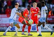 5 May 2025; Mipo Odubeko of Shelbourne in action against Waterford players Kacper Radkowski, left, and James Olayinka during the SSE Airtricity Men's Premier Division match between Shelbourne and Waterford at Tolka Park in Dublin. Photo by Seb Daly/Sportsfile