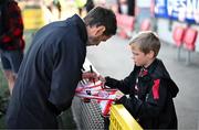 5 May 2025; Derry City manager Tiernan Lynch signs an autograph for a young Derry City supporter before the SSE Airtricity Men's Premier Division match between Derry City and St Patrick's Athletic at The Ryan McBride Brandywell Stadium in Derry. Photo by Stephen McCarthy/Sportsfile