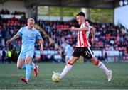5 May 2025; Danny Mullen of Derry City in action against Tom Grivosti of St Patrick's Athletic during the SSE Airtricity Men's Premier Division match between Derry City and St Patrick's Athletic at The Ryan McBride Brandywell Stadium in Derry. Photo by Stephen McCarthy/Sportsfile