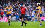 27 April 2025; Referee Chris Mooney awards a free against Adam Hogan of Clare, right, during the Munster GAA Hurling Senior Championship Round 2 match between Waterford and Clare at Walsh Park in Waterford. Photo by Piaras Ó Mídheach/Sportsfile
