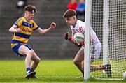 9 May 2025; Mayo goalkeeper Thomas Williams gathers possession under pressure from John Price of Roscommon during the Electric Ireland Connacht GAA Football Minor Championship final match between Roscommon and Mayo at Hastings Insurance MacHale Park in Castlebar, Mayo. Photo by Ben McShane/Sportsfile