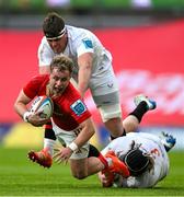 9 May 2025; Craig Casey of Munster is tackled by James McNabney and Scott Wilson of Ulster during the United Rugby Championship match between Munster and Ulster at Thomond Park in Limerick. Photo by Brendan Moran/Sportsfile