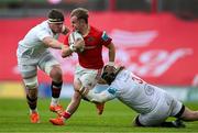 9 May 2025; Craig Casey of Munster is tackled by James McNabney and Scott Wilson of Ulster during the United Rugby Championship match between Munster and Ulster at Thomond Park in Limerick. Photo by Brendan Moran/Sportsfile