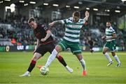 9 May 2025; Lee Grace of Shamrock Rovers in action against Warren Davis of Drogheda United during the SSE Airtricity Men's Premier Division match between Shamrock Rovers and Drogheda United at Tallaght Stadium in Dublin. Photo by David Fitzgerald/Sportsfile