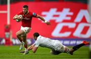 9 May 2025; Diarmuid Kilgallen of Munster beats the tackle of Iain Henderson of Ulster during the United Rugby Championship match between Munster and Ulster at Thomond Park in Limerick. Photo by Brendan Moran/Sportsfile