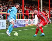 9 May 2025; Chris Forrester of St Patrick's Athletic in action against Kameron Ledwidge of Shelbourne during the SSE Airtricity Men's Premier Division match between Shelbourne and St Patrick's Athletic at Tolka Park in Dublin. Photo by Piaras Ó Mídheach/Sportsfile