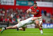 9 May 2025; Alex Nankivell of Munster is tackled by Jude Postlethwaite of Ulster during the United Rugby Championship match between Munster and Ulster at Thomond Park in Limerick. Photo by Brendan Moran/Sportsfile