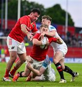 9 May 2025; Craig Casey of Munster is tackled by Jack Murphy of Ulster during the United Rugby Championship match between Munster and Ulster at Thomond Park in Limerick. Photo by Brendan Moran/Sportsfile