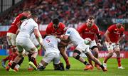 9 May 2025; Michael Milne of Munster loses possession as he is tackled by Cormac Izuchukwu and Rob Herring of Ulster during the United Rugby Championship match between Munster and Ulster at Thomond Park in Limerick. Photo by Brendan Moran/Sportsfile