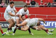 9 May 2025; Calvin Nash of Munster is tackled by Ulster players, Jude Postlethwaite, Jacob Stockdale and Stuart McCloskey during the United Rugby Championship match between Munster and Ulster at Thomond Park in Limerick. Photo by John Dickson/Sportsfile