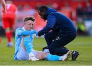 9 May 2025; Chris Forrester of St Patrick's Athletic receives medical attention from St Patrick's Athletic athletic therapist David Mugalu during the SSE Airtricity Men's Premier Division match between Shelbourne and St Patrick's Athletic at Tolka Park in Dublin. Photo by Stephen McCarthy/Sportsfile