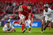 9 May 2025; Tom Farrell of Munster beats the tackle of Jude Postlethwaite of Ulster on the way to scoring his side's fifth try during the United Rugby Championship match between Munster and Ulster at Thomond Park in Limerick. Photo by Brendan Moran/Sportsfile