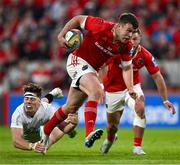 9 May 2025; Tom Farrell of Munster beats the tackle of Jude Postlethwaite of Ulster on the way to scoring his side's fifth try during the United Rugby Championship match between Munster and Ulster at Thomond Park in Limerick. Photo by Brendan Moran/Sportsfile