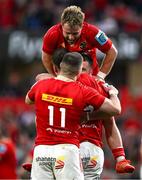 9 May 2025; Craig Casey, top, and Diarmuid Kilgallen of Munster celebrate with teammate Tom Farrell after he scored their side's fifth try during the United Rugby Championship match between Munster and Ulster at Thomond Park in Limerick. Photo by Brendan Moran/Sportsfile