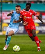 9 May 2025; Mipo Odubeko of Shelbourne in action against Jamie Lennon of St Patrick's Athletic during the SSE Airtricity Men's Premier Division match between Shelbourne and St Patrick's Athletic at Tolka Park in Dublin. Photo by Piaras Ó Mídheach/Sportsfile