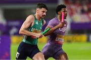 10 May 2025; Cillín Greene of Ireland, left, competes in the mixed 4x400m relay along side Chris Robinson of USA, during day one of the 2025 World Athletics Relays at Guangdong Olympic Stadium in Guangzhou, China. Photo by Nikola Krstic/Sportsfile