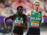 10 May 2025; Rhasidat Adeleke of Ireland, left, takes the baton from teammate Conor Kelly whilst competing in the mixed 4x400m during day one of the 2025 World Athletics Relays at Guangdong Olympic Stadium in Guangzhou, China. Photo by Nikola Krstic/Sportsfile
