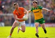 10 May 2025; Tiernan Kelly of Armagh in action against Shane O'Donnell of Donegal during the Ulster GAA Football Senior Championship final match between Armagh and Donegal at St Tiernach's Park in Clones, Monaghan. Photo by David Fitzgerald/Sportsfile