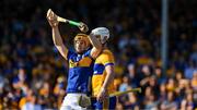 10 May 2025; Jake Morris of Tipperary is marked closly by Daithi Lohan of Clare during the Munster GAA Hurling Senior Championship Round 3 match between Clare and Tipperary at Zimmer Biomet Páirc Chíosóg in Ennis, Clare. Photo by Ray McManus/Sportsfile
