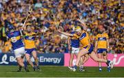 10 May 2025; Alan Tynan of Tipperary gets a shot off despite the efforts of Clare players, from left, Tony Kelly and Sean Rynne during the Munster GAA Hurling Senior Championship Round 3 match between Clare and Tipperary at Zimmer Biomet Páirc Chíosóg in Ennis, Clare. Photo by John Sheridan/Sportsfile