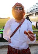 10 May 2025; Munster supporter Dean Shannon enjoys a slice of pizza at half-time in the United Rugby Championship match between Connacht and Edinburgh at Dexcom Stadium in Galway. Photo by Thomas Flinkow/Sportsfile