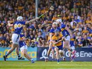 10 May 2025; Shane O Donnell of Clare passes the sliothar under pressure from Tipperary players including Peter McGarry during the Munster GAA Hurling Senior Championship Round 3 match between Clare and Tipperary at Zimmer Biomet Páirc Chíosóg in Ennis, Clare.