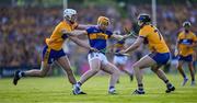 10 May 2025; Jake Morris of Tipperary is tackled by Cian Galvin and David McInerney of Clare during the Munster GAA Hurling Senior Championship Round 3 match between Clare and Tipperary at Zimmer Biomet Páirc Chíosóg in Ennis, Clare. Photo by Ray McManus/Sportsfile