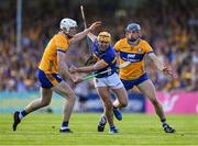 10 May 2025; Conor Stakelum of Tipperary is tackled by David McInerney, left, and Cian Galvin of Clare during the Munster GAA Hurling Senior Championship Round 3 match between Clare and Tipperary at Zimmer Biomet Páirc Chíosóg in Ennis, Clare. Photo by Ray McManus/Sportsfile