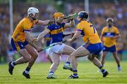 10 May 2025; Jake Morris of Tipperary is tackled by Cian Galvin and David McInerney of Clare during the Munster GAA Hurling Senior Championship Round 3 match between Clare and Tipperary at Zimmer Biomet Páirc Chíosóg in Ennis, Clare. Photo by Ray McManus/Sportsfile