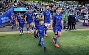 10 May 2025; Mascots walk out with Luke McGrath of Leinster before the United Rugby Championship match between Leinster and Zebre Parma at the Aviva Stadium in Dublin. Photo by Brendan Moran/Sportsfile
