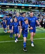 10 May 2025; Mascots walk out with Josh van der Flier, Jamie Osborne, Thomas Clarkson and Jack Boyle of Leinster before the United Rugby Championship match between Leinster and Zebre Parma at the Aviva Stadium in Dublin. Photo by Brendan Moran/Sportsfile