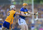 10 May 2025; Jake Morris of Tipperary is tackled by Cian Galvin of Clare during the Munster GAA Hurling Senior Championship Round 3 match between Clare and Tipperary at Zimmer Biomet Páirc Chíosóg in Ennis, Clare. Photo by Ray McManus/Sportsfile