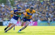 10 May 2025; David Fitzgerald of Clare is tackled by Alan Tynan of Tipperary during the Munster GAA Hurling Senior Championship Round 3 match between Clare and Tipperary at Zimmer Biomet Páirc Chíosóg in Ennis, Clare. Photo by Ray McManus/Sportsfile