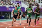 11 May 2025; Chris O'Donnell of Ireland, left, takes the baton from teammate Cillín Greene, second from left, whilst competing in the men's 4x400m World Championship Qualifying Round 2 during day two of the 2025 World Athletics Relays at Guangdong Olympic Stadium in Guangzhou, China. Photo by Nikola Krstic/Sportsfile