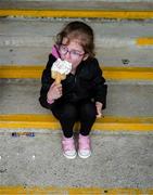 11 May 2025; Sligo supporter five year old Saoirse Meehan, from Kesh, Ballymote, enjoys an ice cream before the Táilteann Cup match between Sligo and Tipperary at Kilcoyne Memorial Park in Tubbercurry, Sligo. Photo by Ray McManus/Sportsfile