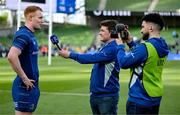 10 May 2025; Ciarán Frawley of Leinster is interviewed by Paul Cahill and Bernardo Santos, right, of Leinster Rugby after the United Rugby Championship match between Leinster and Zebre Parma at the Aviva Stadium in Dublin. Photo by Brendan Moran/Sportsfile
