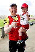 11 May 2025; Tyrone coach Diarmaid McNulty with son Hugh, age 2, after their side's victory in the Dalata Hotel Group GAA Football All-Ireland U20 Championship semi-final match between Kerry and Tyrone at Laois Hire O'Moore Park in Portlaoise, Laois. Photo by Thomas Flinkow/Sportsfile